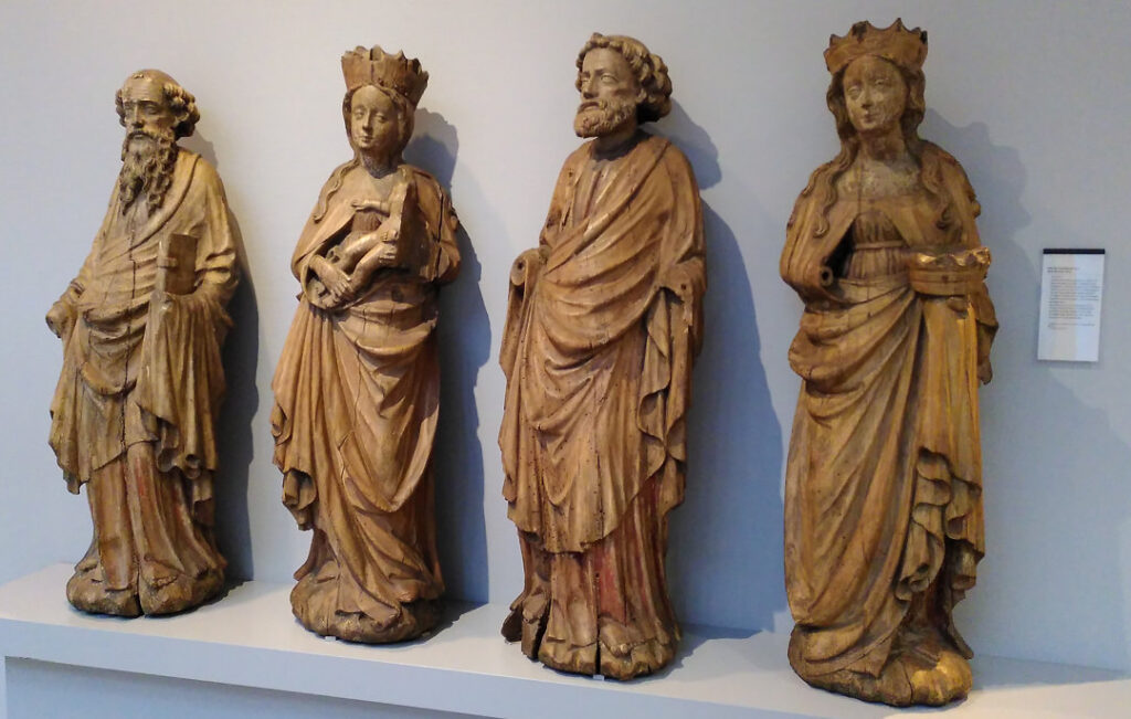 A photo of four wooden statues