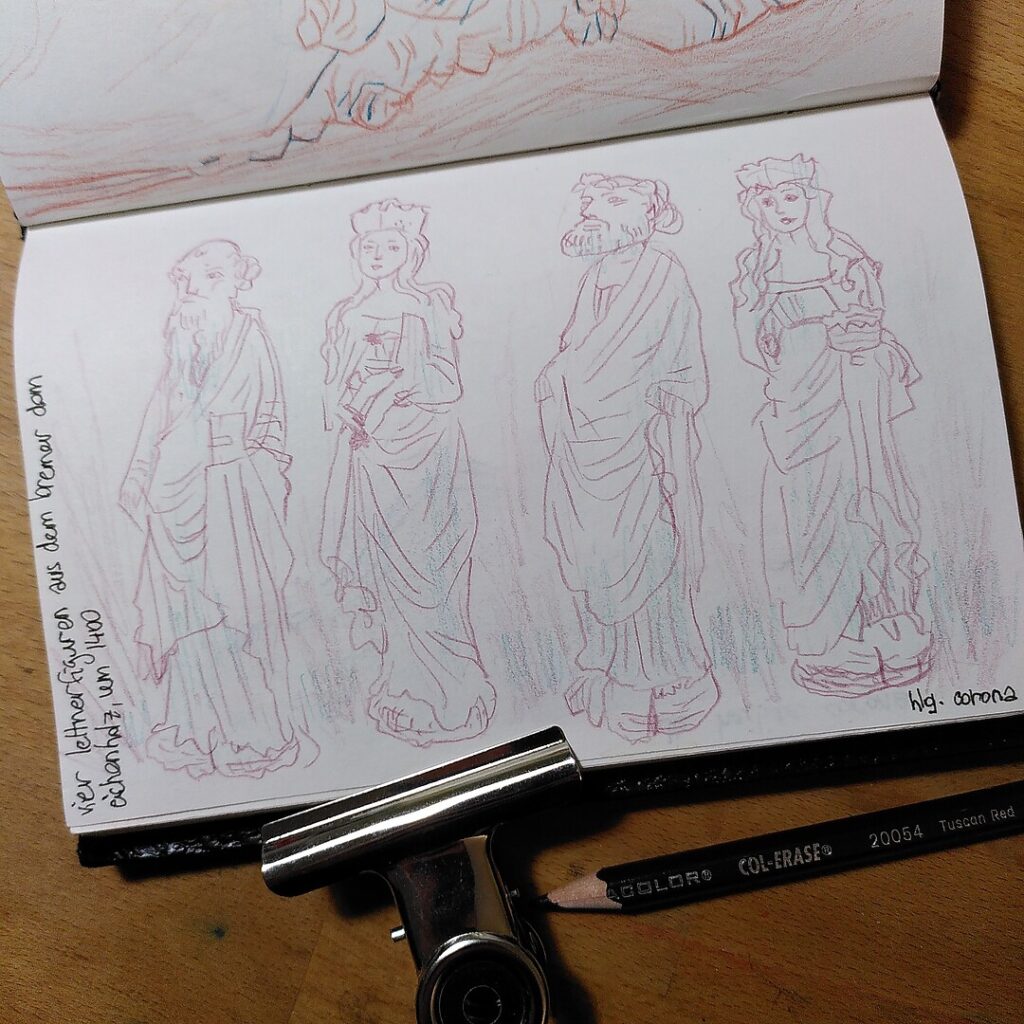 A photo of a sketchbook page with a colour pencil drawing of four statues, and a Col-Erase colour pencil, colour Tuscan Red