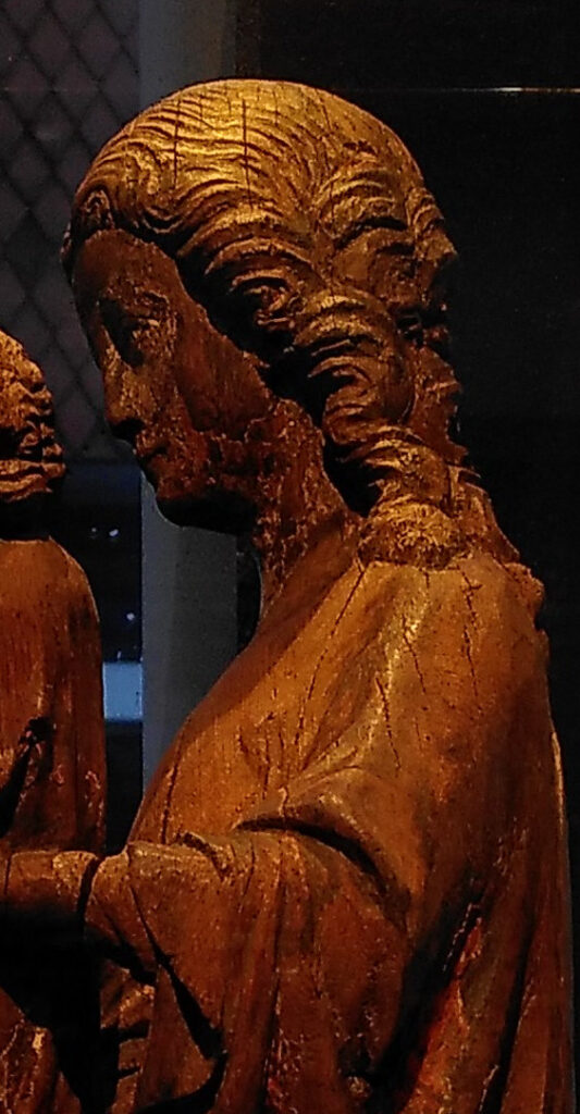 A photo of a wooden sculpture of a woman, cropped
